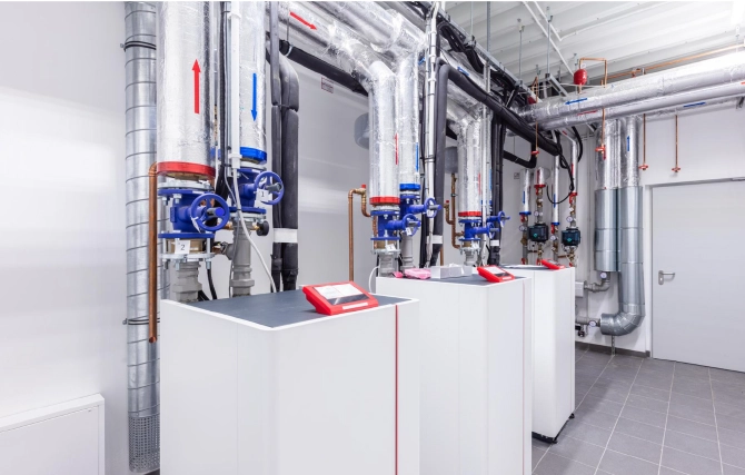 Industrial boiler system with large piping, valves, and mechanical equipment used for commercial heating and process applications.