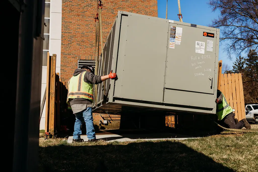 All Hours Mechanical technicians performing commercial HVAC unit replacement outdoors